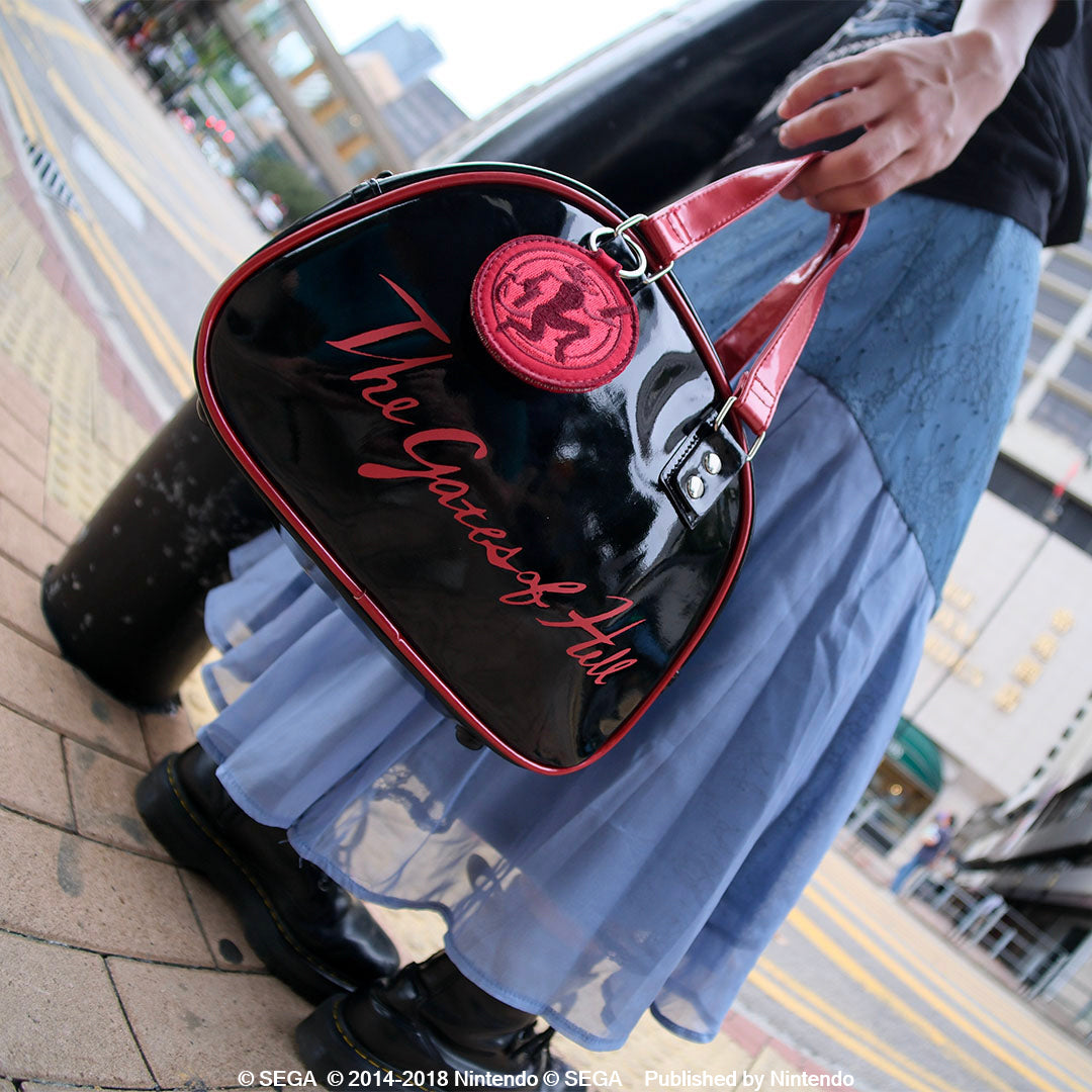 The Gates of Hell lettering gleams across an enamel Boston bag. On the reverse, a patch inspired by a wax seal.
